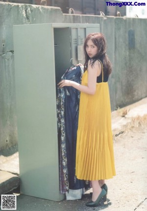 A woman sitting on top of a blue chair.