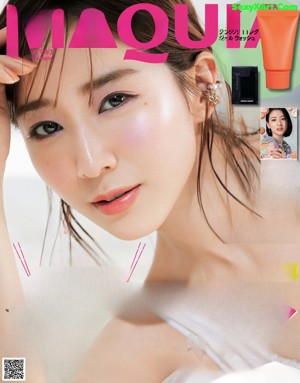 A magazine with a picture of a woman in a white dress.