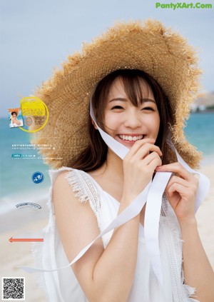 A woman in a straw hat on the cover of a magazine.