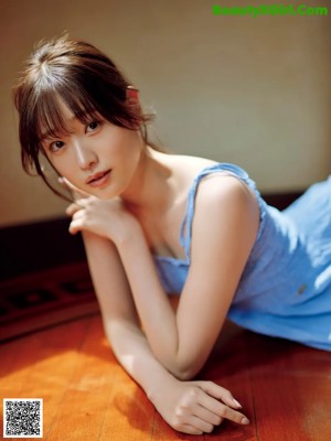 A woman sitting on a couch with her legs crossed.