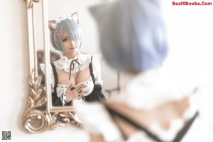 A woman in a cat costume is sitting on a bed.