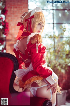 A woman in a bunny costume sitting on the floor.