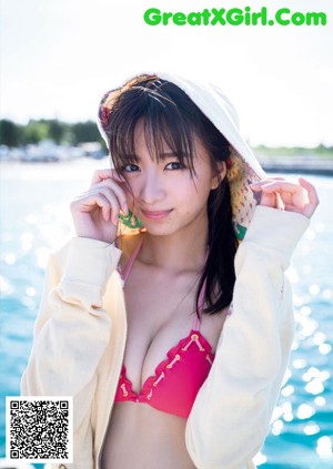 A woman in a blue bathing suit in a pool.