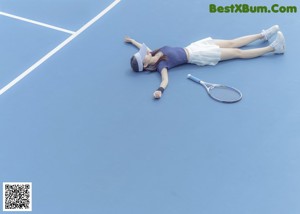 A woman laying on the ground next to a pink pipe.