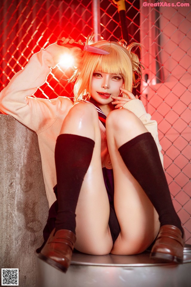 A woman sitting on top of a cement block holding a knife.